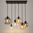 Lustre industriel 6 lumières Orive, globes de verre et platine noire sur fond neutre