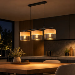 Suspension TRIOLA allumée le soir au-dessus d’une table de cuisine, lumière chaude